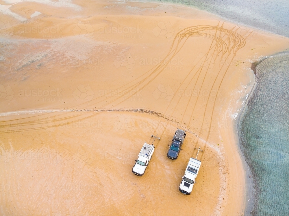 Aerial view of three 4wd's and their tyre tracks on a sandbar - Australian Stock Image