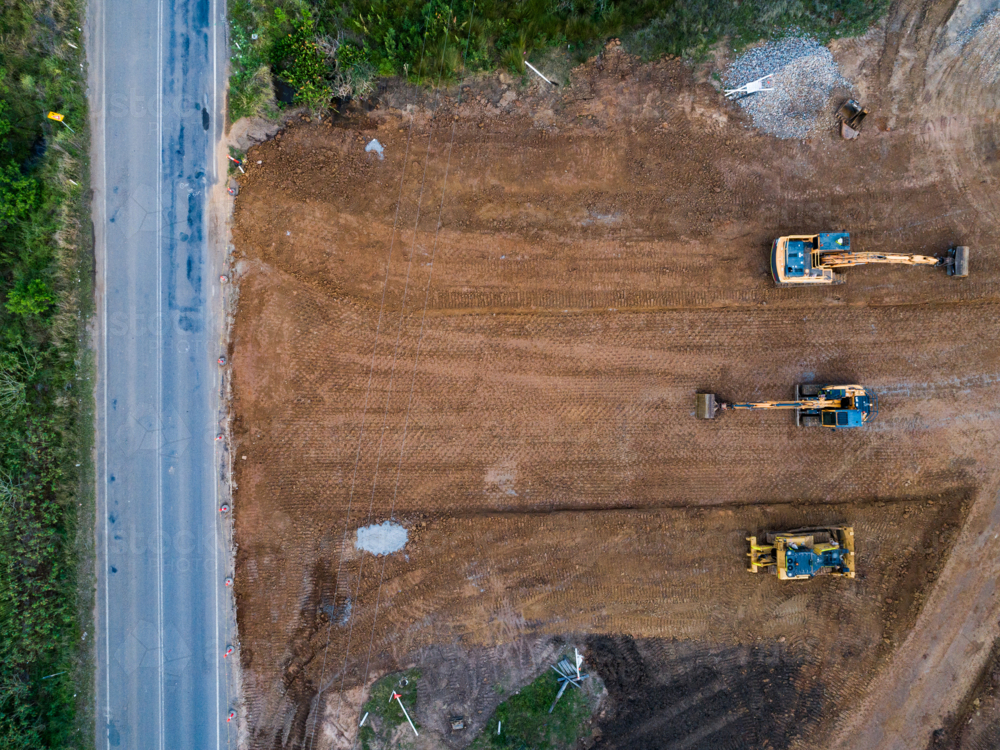 Aerial view of three earthmoving machinery on construction site for Singleton Bypass - Australian Stock Image
