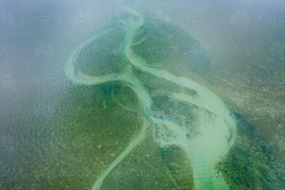 Aerial view of tidal patterns and sand bars in a coastal estuary - Australian Stock Image