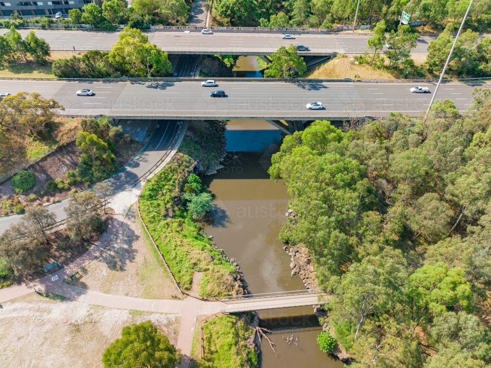 Aerial view of traffic on a multi-lane freeway bridge over a river - Australian Stock Image