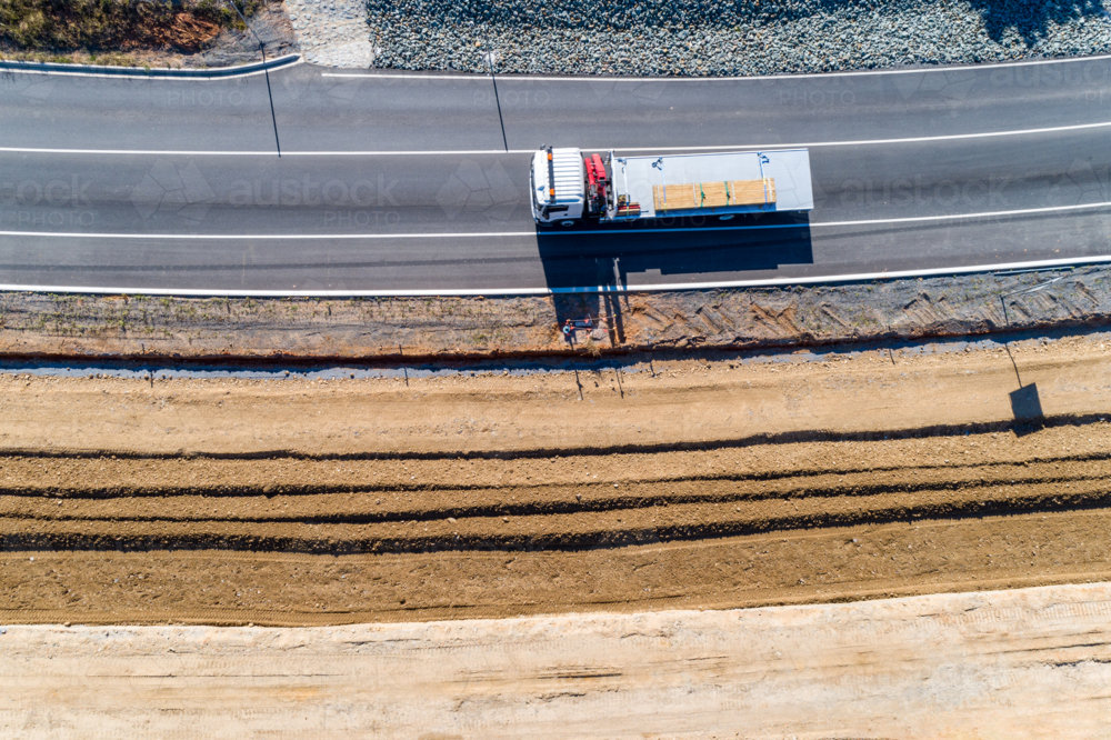 Aerial view of truck driving on road widening roadworks - Australian Stock Image