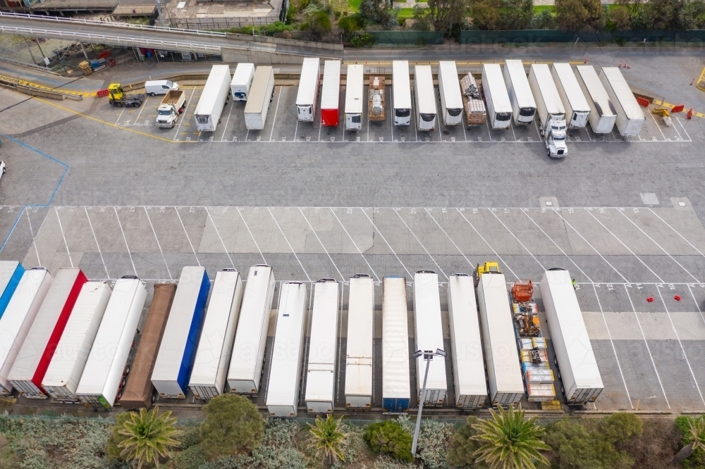 Aerial view of trucks lined up in parking bays at a ferry terminal - Australian Stock Image