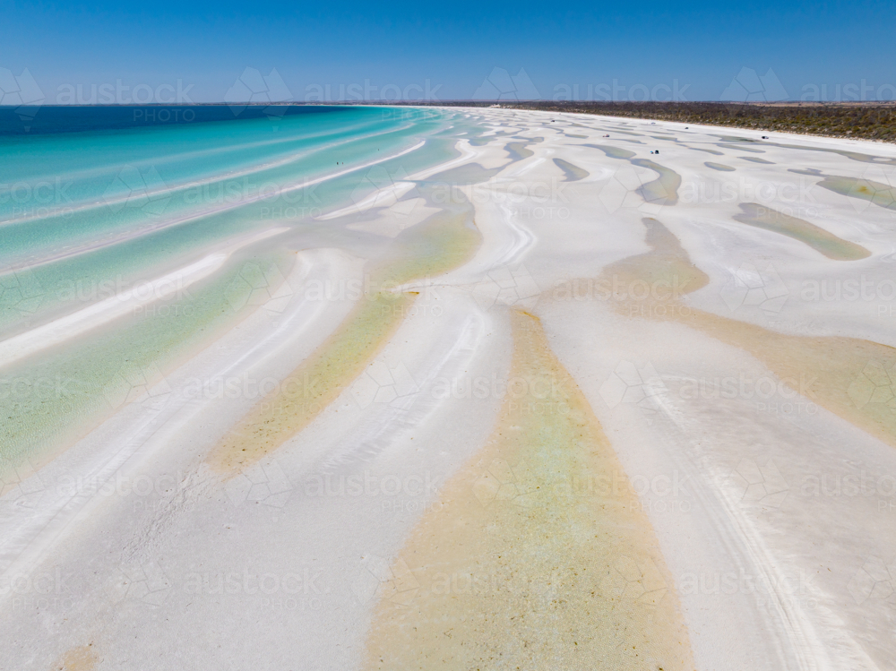 Aerial view of turquoise water along a pristine white sandy beach - Australian Stock Image