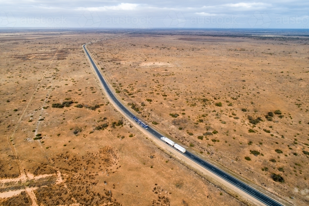 Aerial view of two trucks on Eyre Highway along the Nullarbor Plain - Australian Stock Image