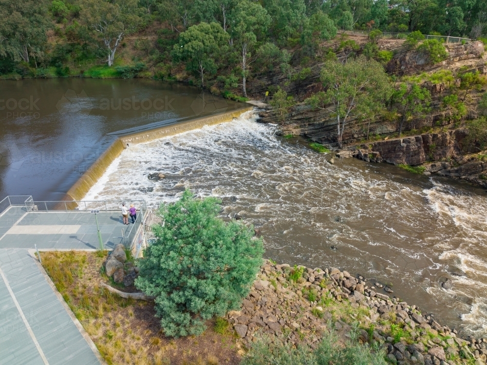 Aerial view of water rushing over a waterfall and down a river - Australian Stock Image