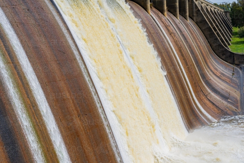 Image of Aerial view of water spilling over a weir - Austockphoto