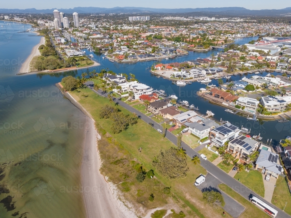 Aerial view of waterfront properties with private jetties along the edges of coastal canals - Australian Stock Image