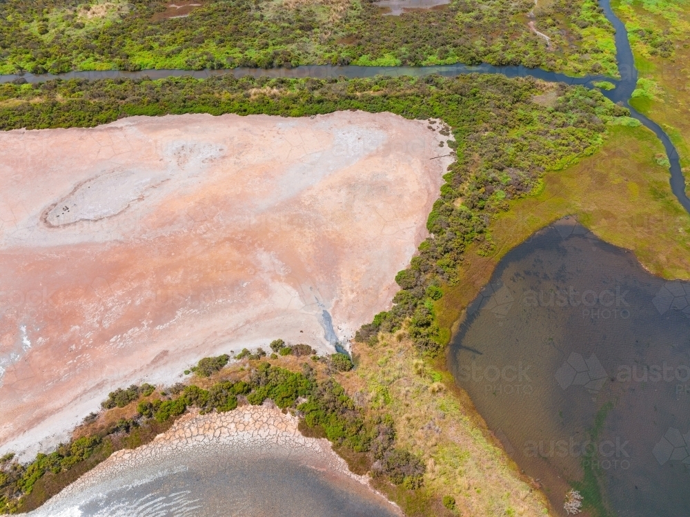 Aerial view of wetlands with colourful vegetation and dry salt lake - Australian Stock Image