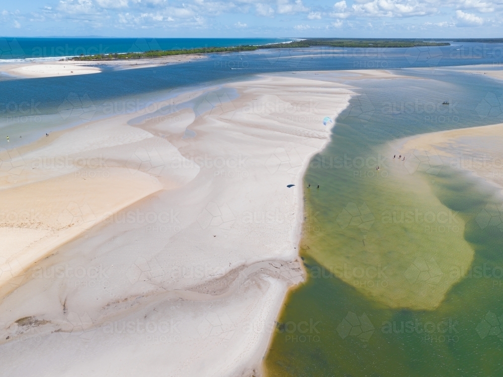 Aerial view of white sand bars around in a river mouth near blue sea - Australian Stock Image