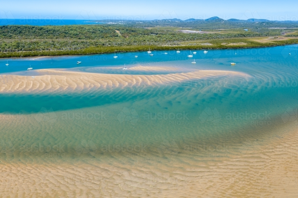 Aerial view of yachts anchored in Round Hill Creek at the Town of 1770, QLD. - Australian Stock Image