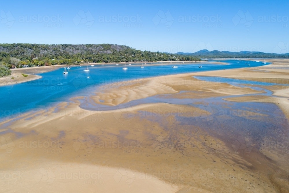 Aerial view of yachts and tidal flats in an estuary at the Town of 1770, QLD. - Australian Stock Image