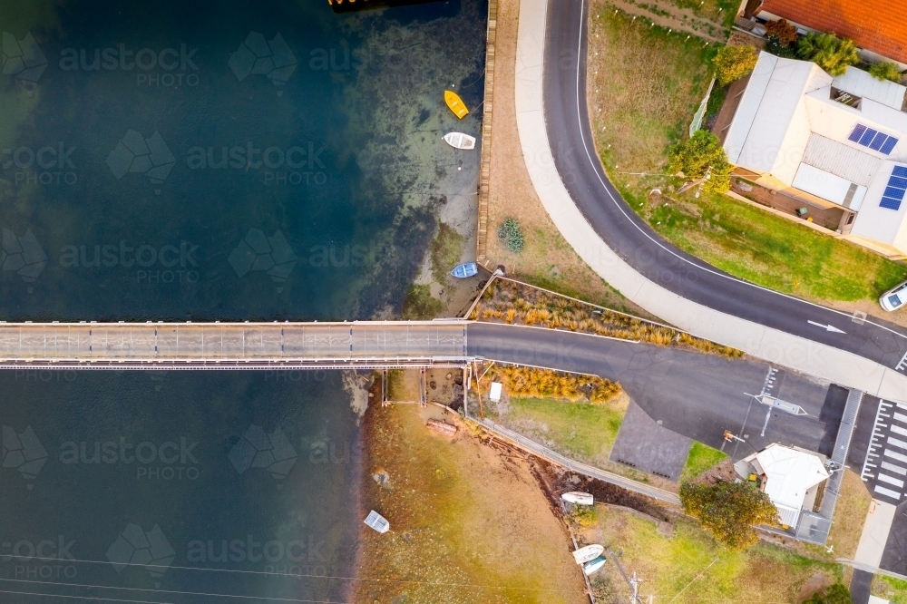 Aerial view over a fork in the road going over a bridge - Australian Stock Image