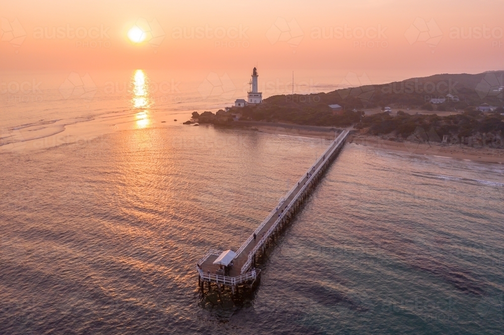 Aerial view over a sunset of the Point Lonsdale Lighthouse and jetty - Australian Stock Image