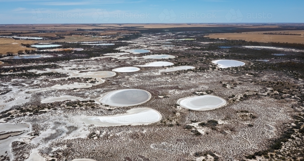 aerial view over chain of salt lakes in arid landscape - Australian Stock Image