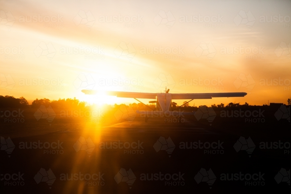 Aeroplane silhouette taking off into the sunset - Australian Stock Image