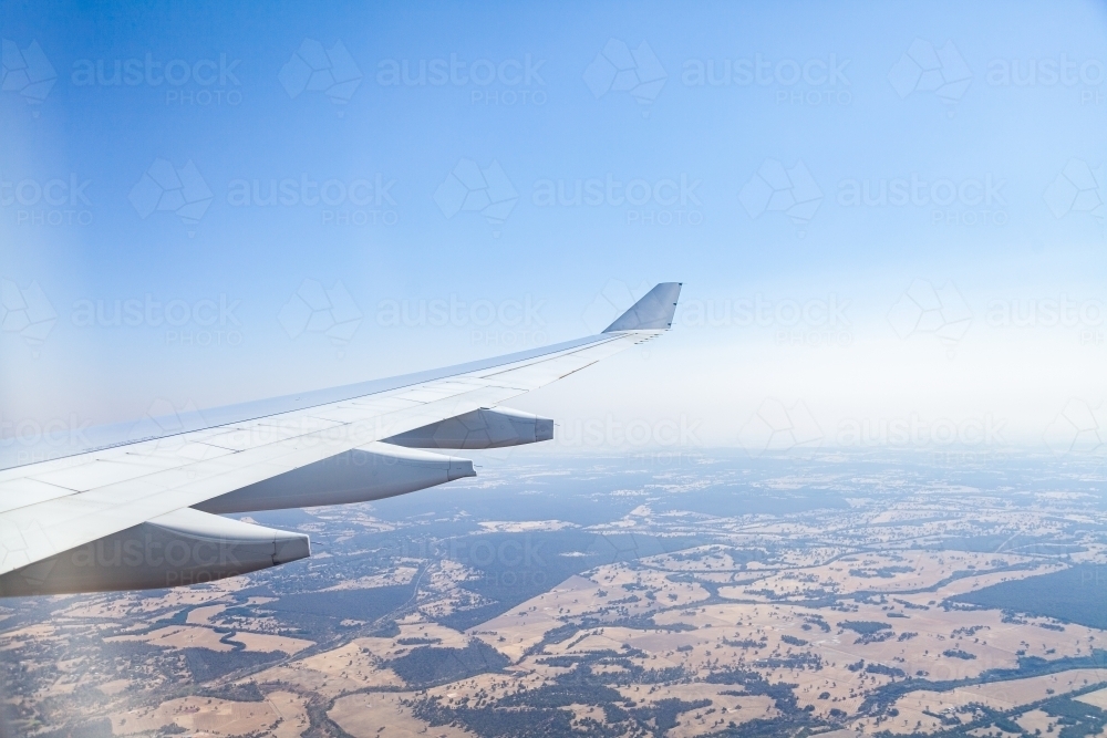 Air Plane wing and distant trees and farm land - Australian Stock Image