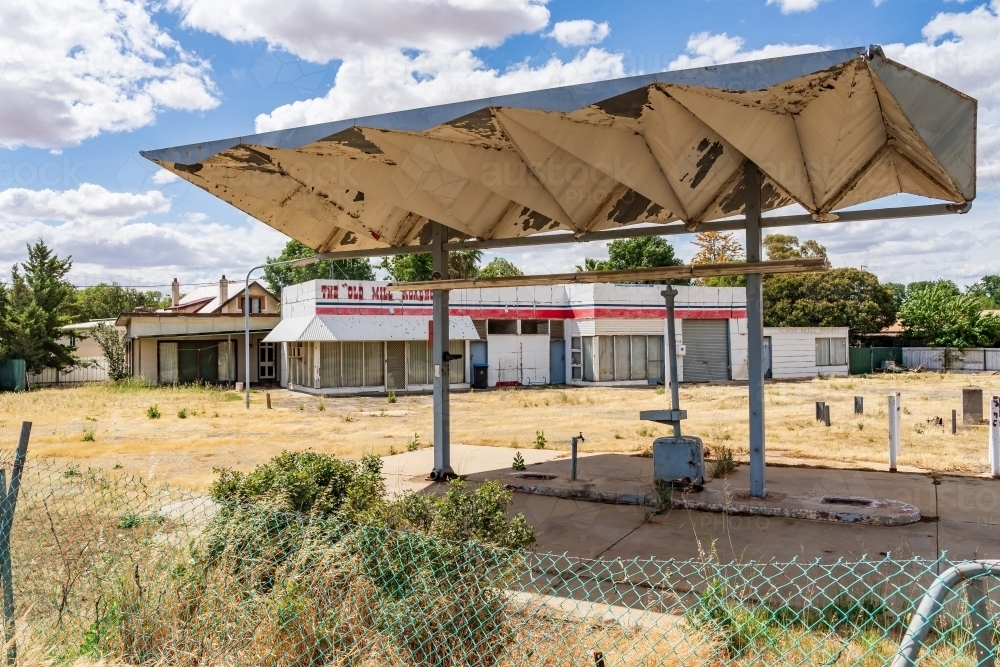 An abandoned petrol station with a large triangular veranda in front - Australian Stock Image