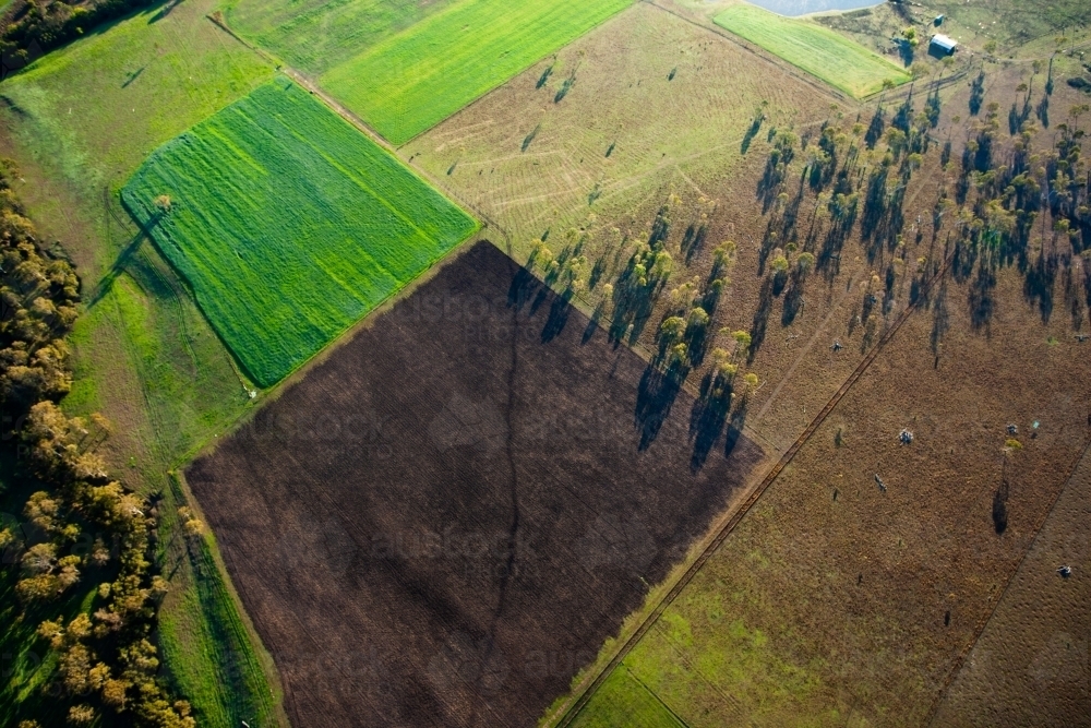 An aerial view of the land and paddocks early in the morning in Ipswich. Queensland, Australia. - Australian Stock Image