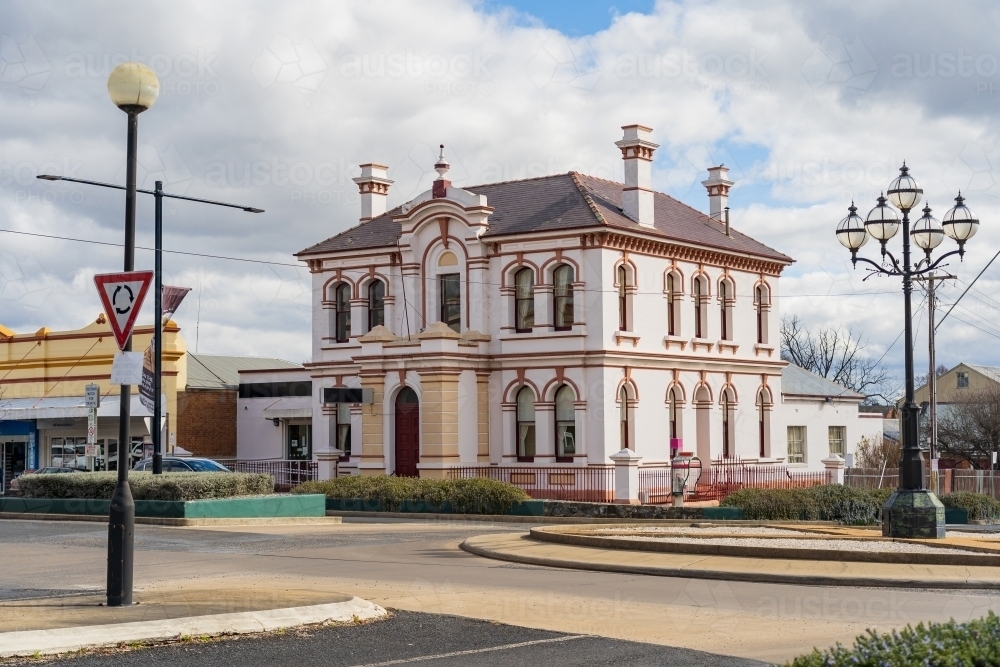 An historic two storey bank building alongside a roundabout with an old fashioned lamppost - Australian Stock Image