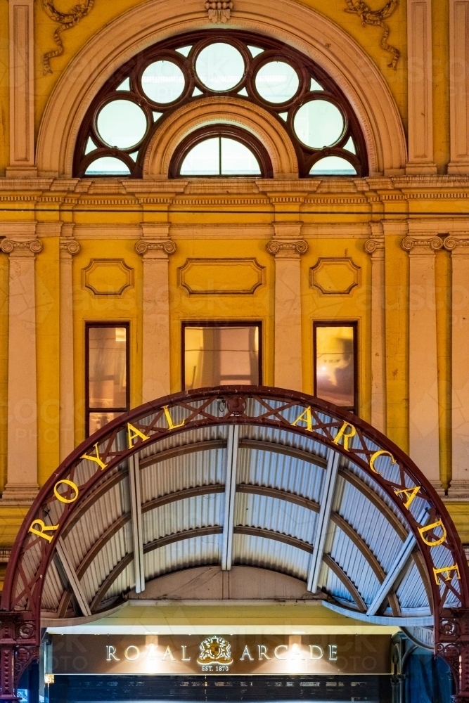 Archways over the entrance to a shopping arcade at night - Australian Stock Image