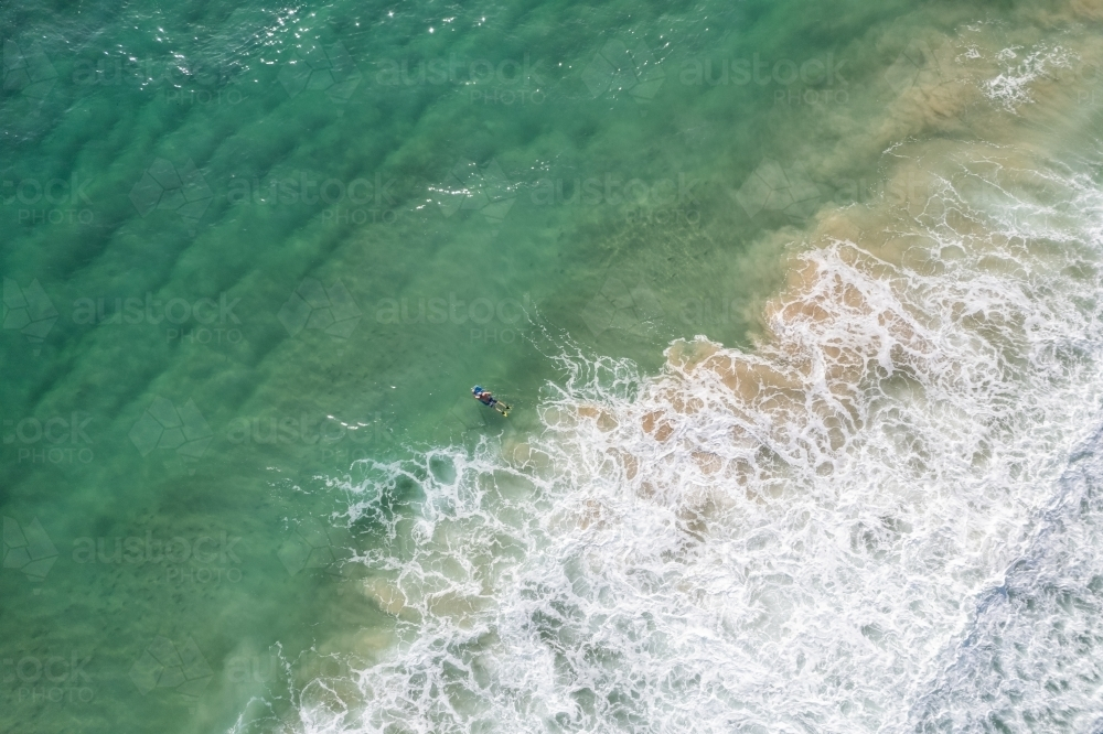 Arial view of the ocean where the waves are breaking near the shore. - Australian Stock Image