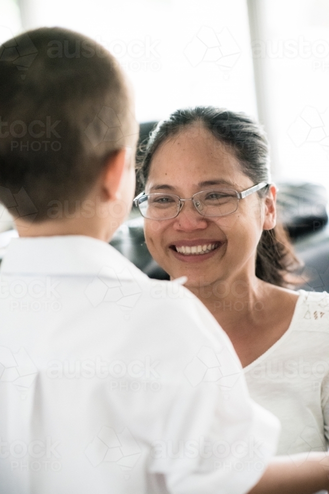 Asian mum saying good-bye to her son on his first day of school - Australian Stock Image