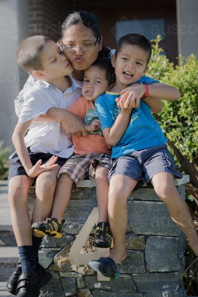 Asian mum sending her boys off to school on their first day of school - Australian Stock Image