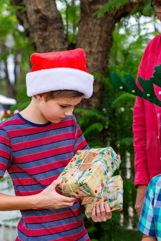 Aussie kids holding Christmas gifts received from family - Australian Stock Image