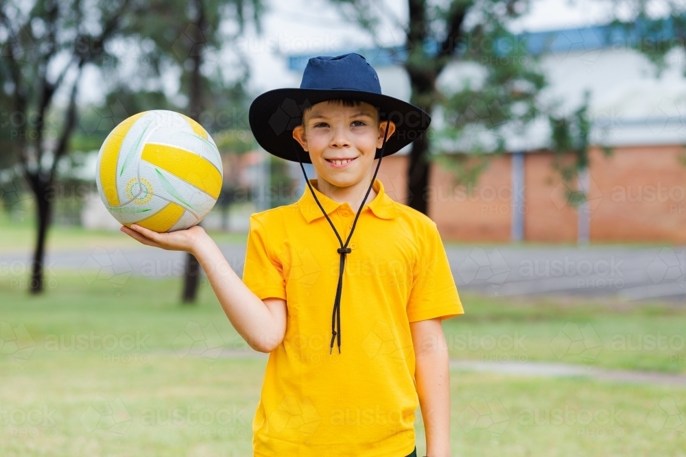 Aussie school boy with ball ready to play sports - Australian Stock Image