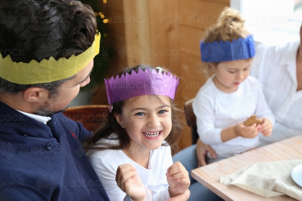 Dad with daughter smiling wearing Christmas hats - Australian Stock Image