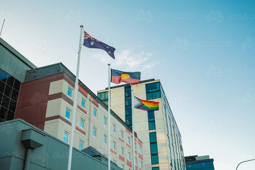 Australian, Aboriginal and LQBTQ+ pride flags flying outside buildings in Sydney street - Australian Stock Image