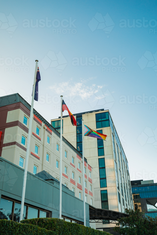 Australian, Aboriginal and LQBTQ+ pride flags flying outside buildings in Sydney street - Australian Stock Image