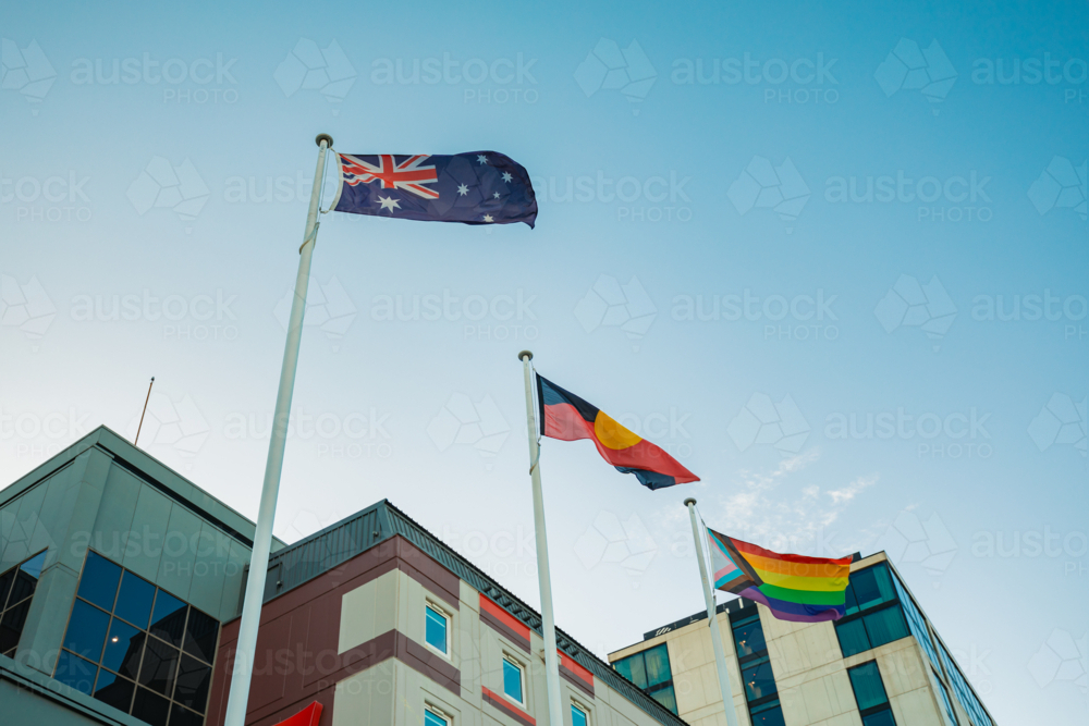 Australian, Aboriginal and LQBTQ+ pride flags flying outside buildings in Sydney street - Australian Stock Image