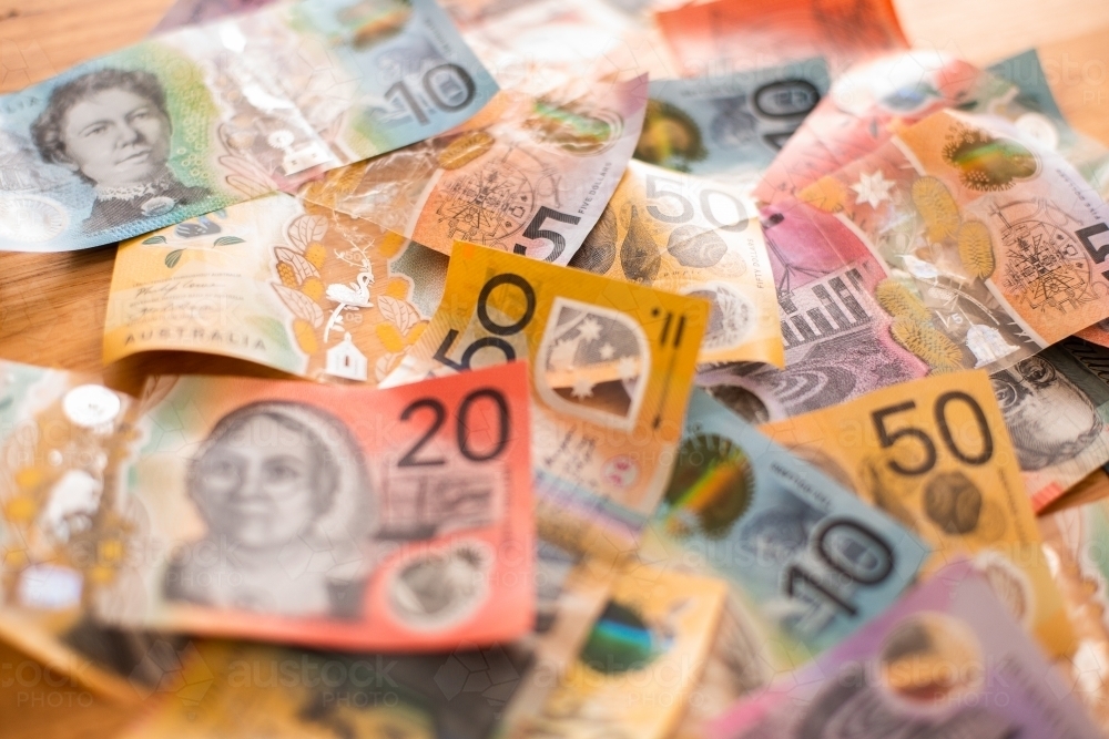 Australian currency notes in a colourful messy pile - Australian Stock Image