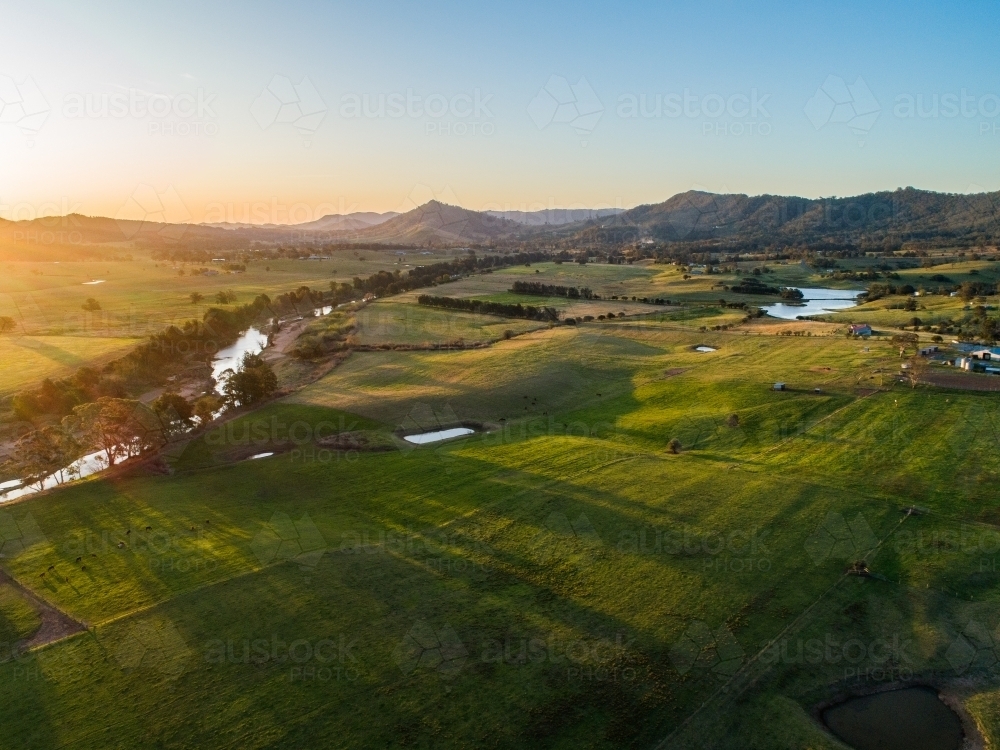 Image of Australian farmland with river flowing through it at sunset ...