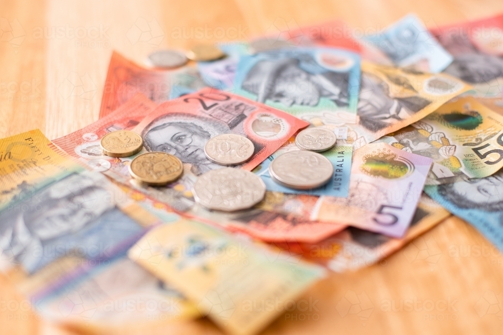 Australian money each of the coins on a pile of notes - Australian Stock Image