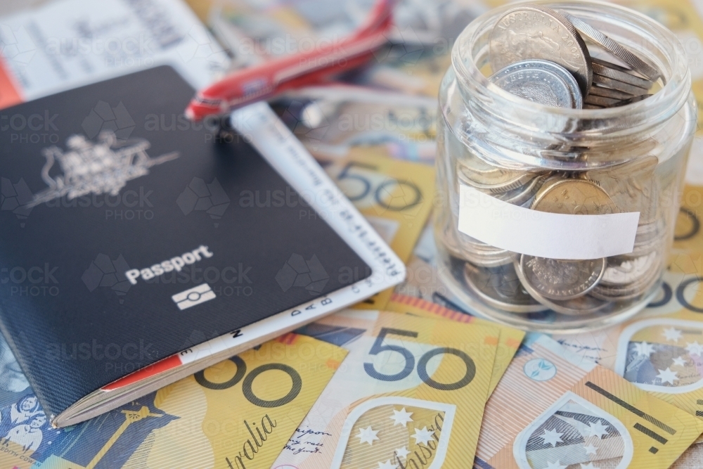 Australian money in glass jar and passport, travel, insurance concept - Australian Stock Image