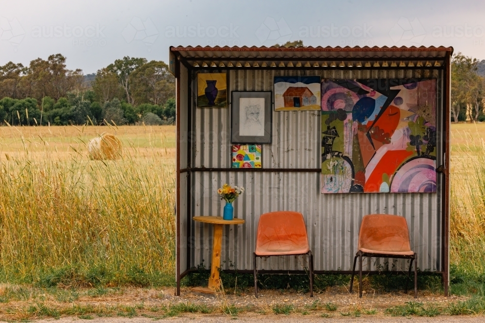 Authentic Aussie school bus stop with bright colours decorated with children's art - Australian Stock Image