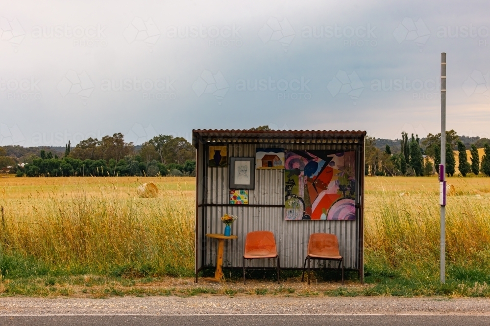 Authentic Aussie school bus stop with bright colours decorated with children's art - Australian Stock Image