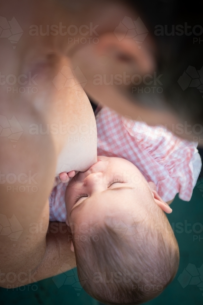 Breastfeeding illustration, mother feeding a baby with breast with