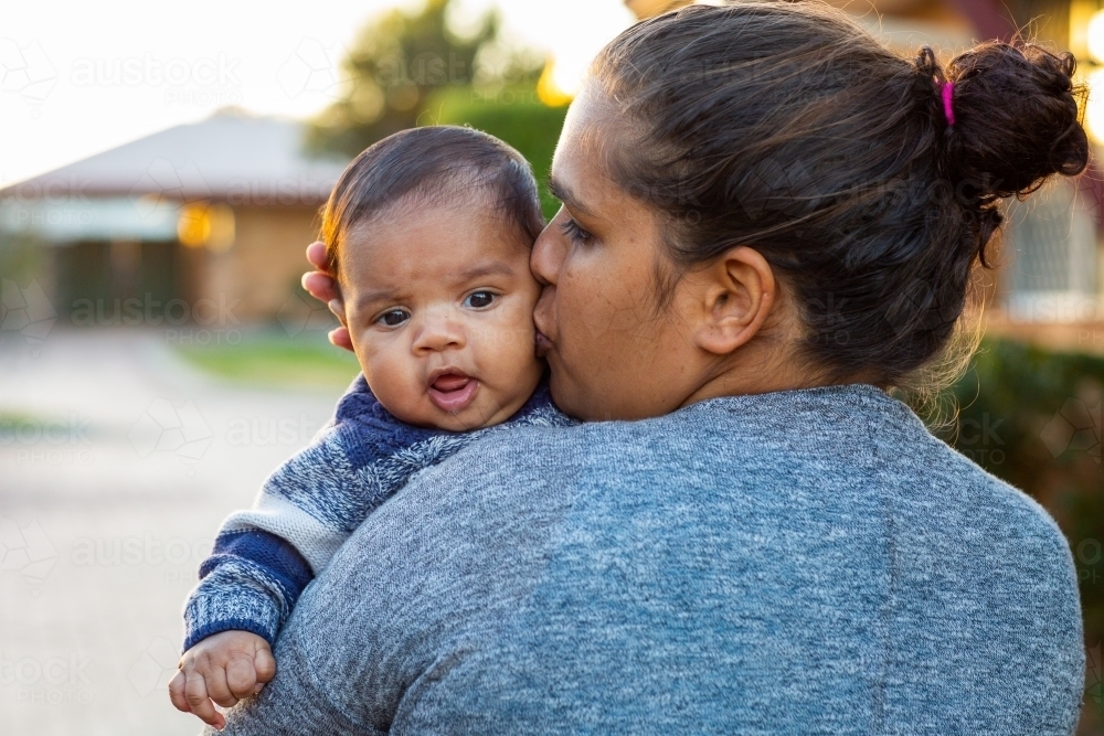 Baby looking over his mother's shoulder - Australian Stock Image