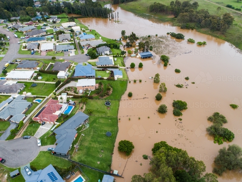 Image of Backyards of homes full of brown floodwater from river ...