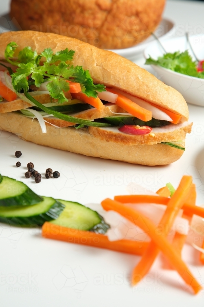 Banh mi with ingredients on white table - Australian Stock Image