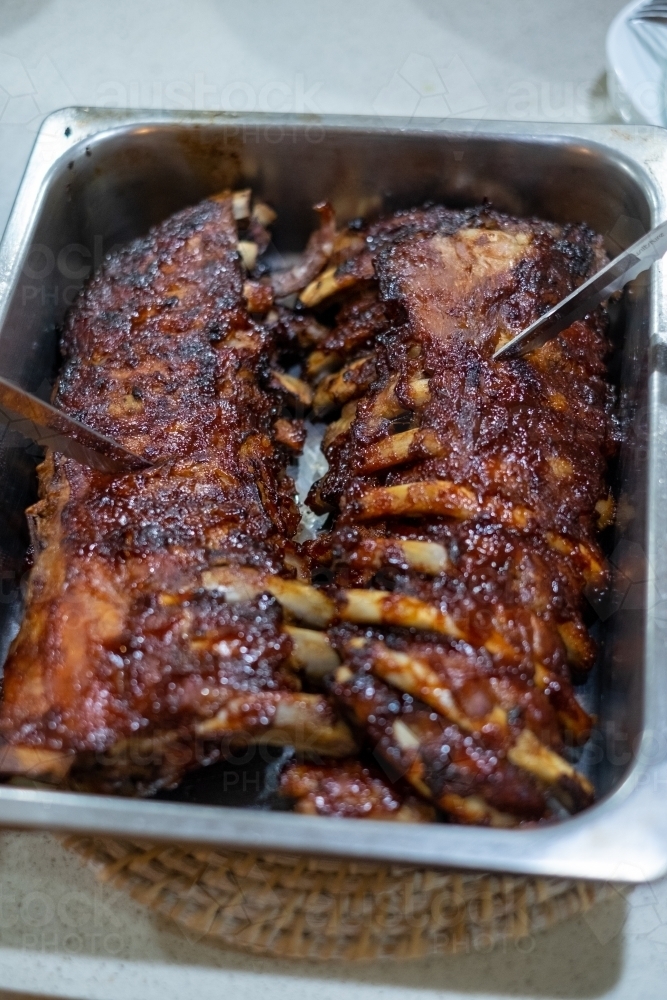 barbecued pork ribs in a dish - Australian Stock Image