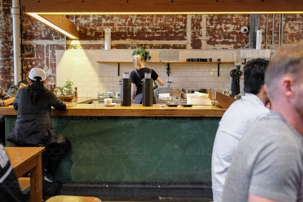 Barista and customers in coffee shop - Australian Stock Image