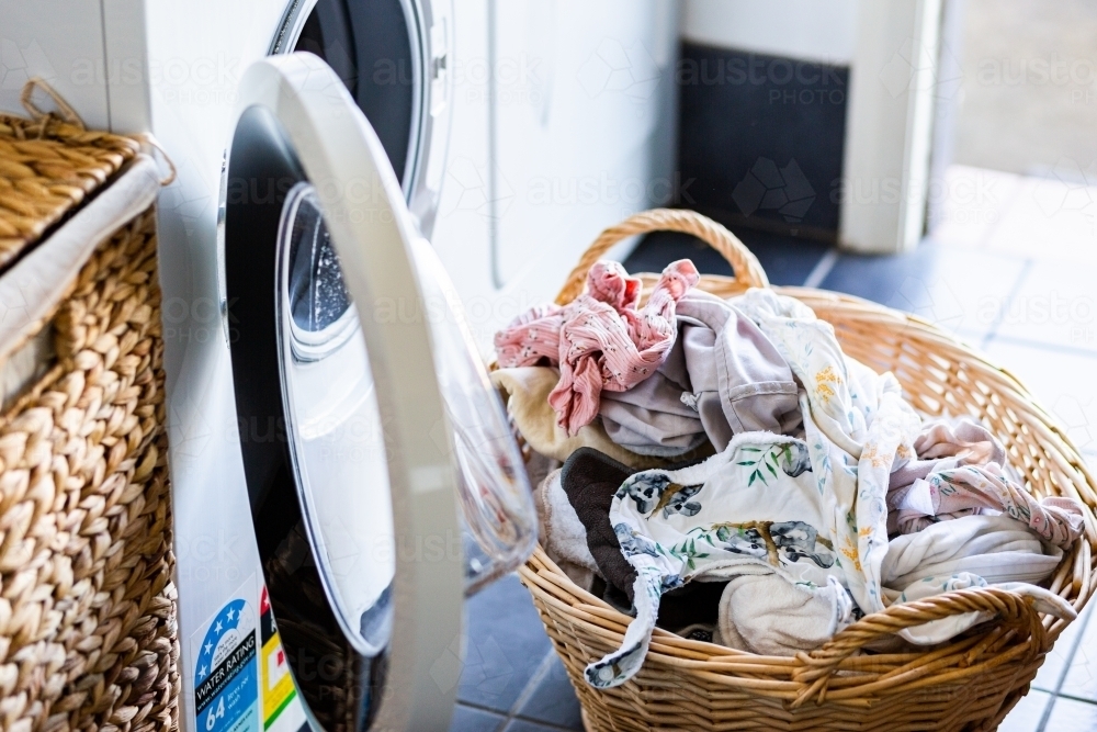 Basket of clean washed washing in laundry ready to be hung up to dry - Australian Stock Image