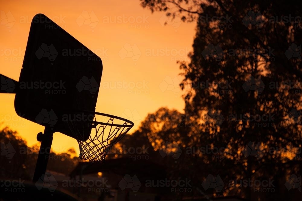 Basketball net silhouette in a golden sunrise - Australian Stock Image