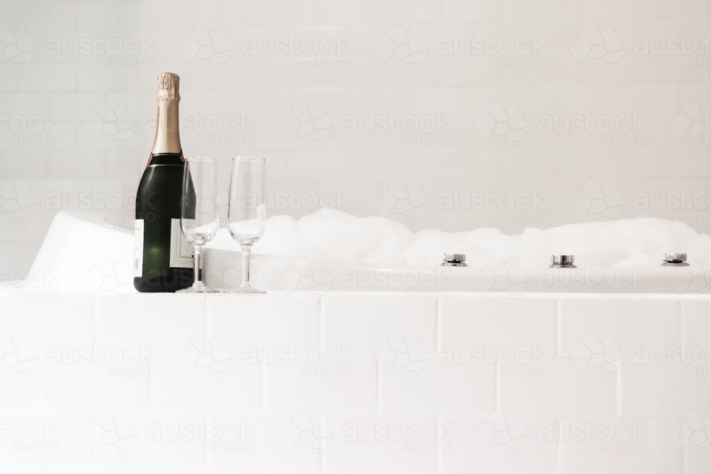 bathtub with champagne and glasses - Australian Stock Image