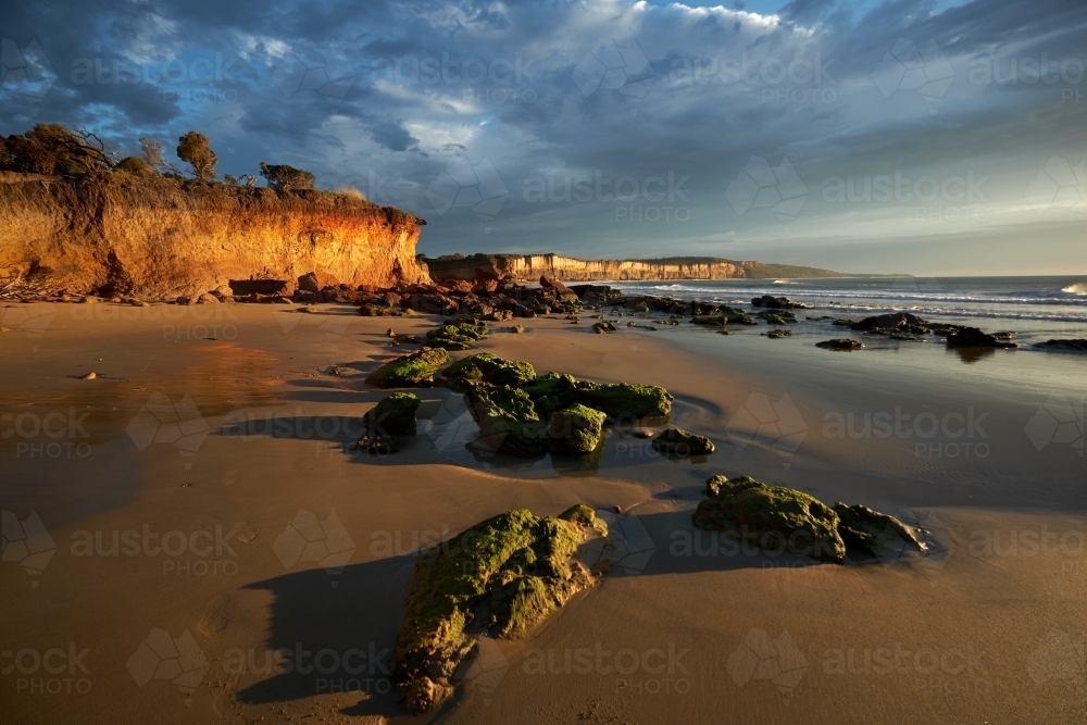 Image of Beach Rocks and Cliffs at Anglesea Beach at Dawn - Austockphoto