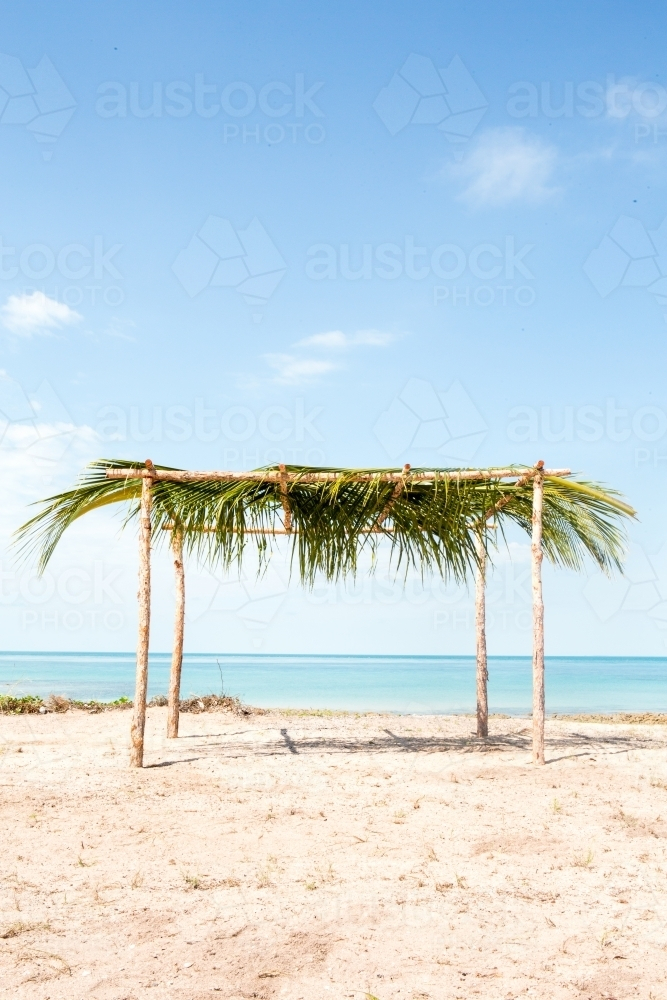 Beach shed with a thatched palm leaf as a roof. - Australian Stock Image